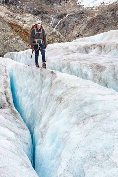 istock Balancing between icy crevasses in Alaska 607486208