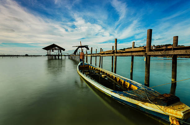 istock fishing moored at sea. Clouds and light evening twilight 607487012