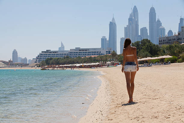 Summer vacation happiness carefree joyful woman walking on Dubai stock photo