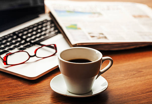 istock office working desk top view with laptop, notepad and coffee 607490030