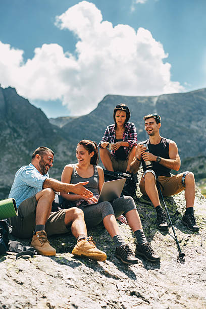 Friends browsing the net in the mountain
