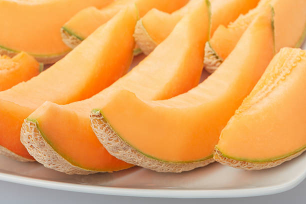 istock Cantaloupe melon, orange slices on dish 607492366