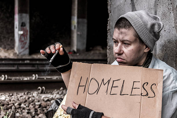 istock Homeless woman smoking 607493274