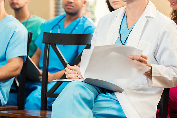 istock Doctor reviews material during meeting 607493540