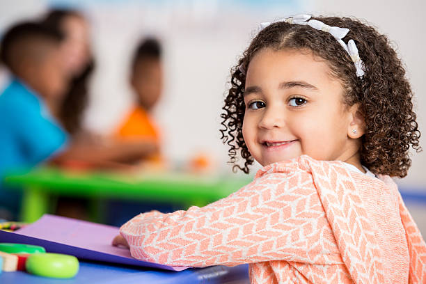 istock Adorable girl in preschool classroom 607493730