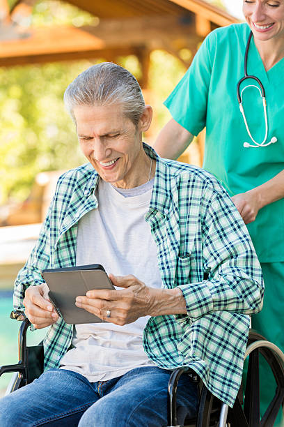 istock Senior man uses a tablet to video chat with family 607494524