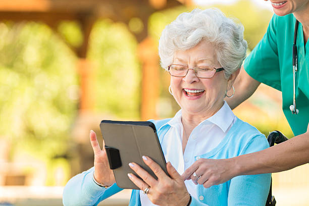 istock Proud senior woman learns to use a digital tablet 607494770