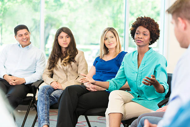 istock African American woman participates in group therapy 607494850