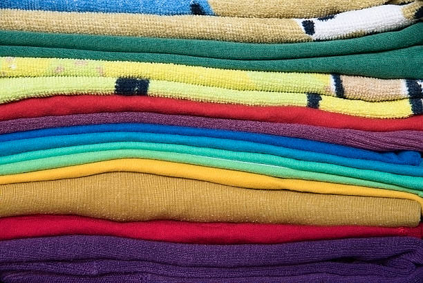 istock close up of colorful folded clothes 607495916