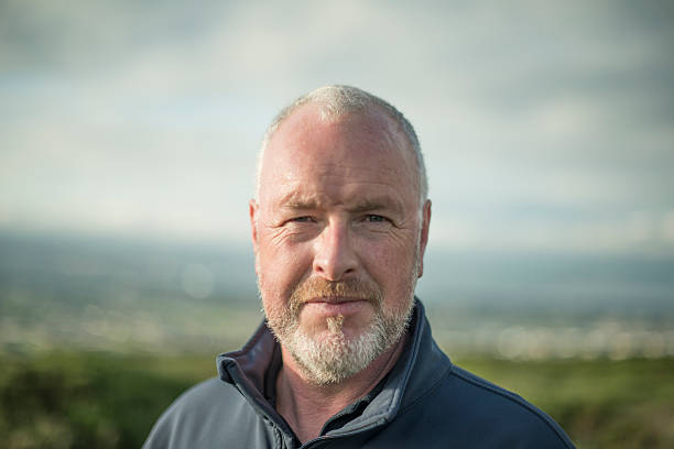 Middle aged man looking to camera in the outdoors, Ticknock, Dublin mountains, Dublin, Ireland.  