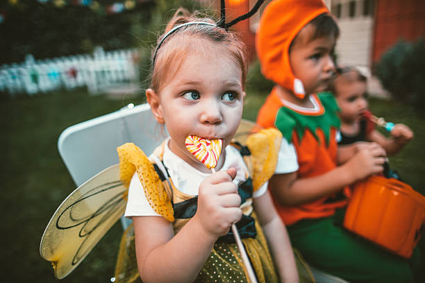 Eating some Halloween candy Eating candy in our backyard after the Halloween halloween treats stock pictures, royalty-free photos & images