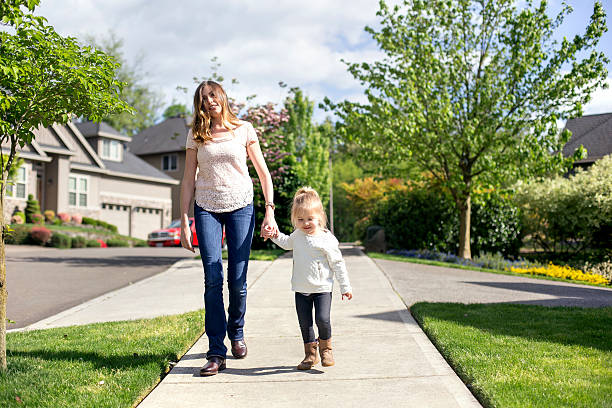 istock Cute young mother holds her daughters hand 607498056