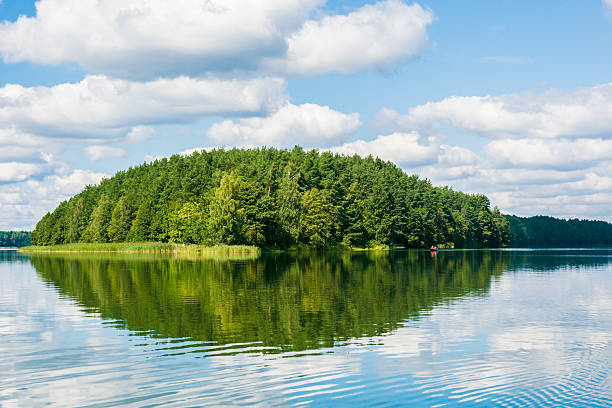 istock green island and lake with Sky reflection 607498418