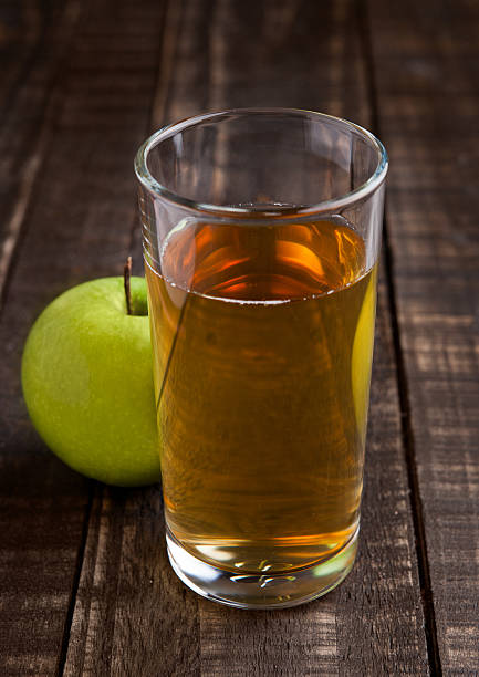 istock Apple juice glass with healthy green apples 607498472