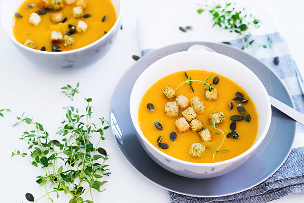 pumpkin soup served with croutons and pumpkin seeds - kruton stok fotoğraflar ve resimler