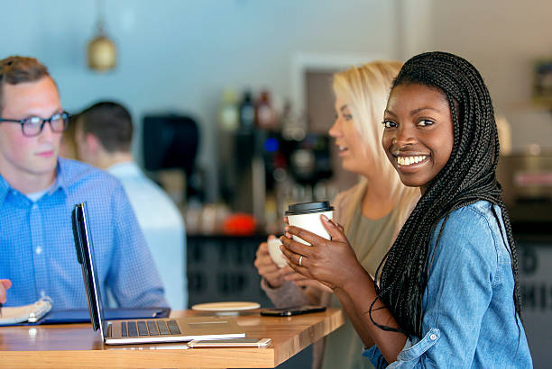 istock Beautiful African American female smiling while drinking coffee 607498898