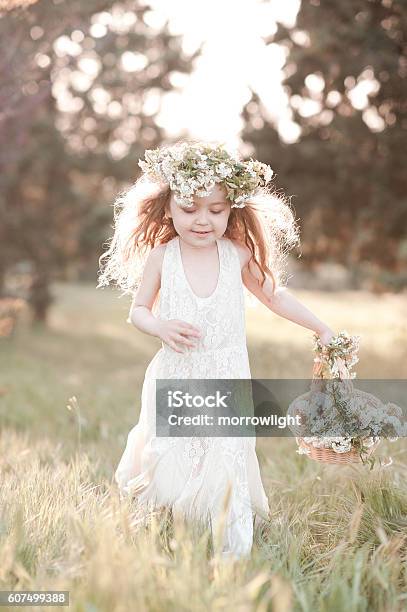 Happy Girl Running In Field Stock Photo - Download Image Now - Child, Flower, Agricultural Field