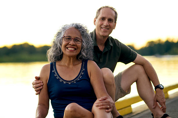 istock Beautiful elderly diverse couple by the river 607499400