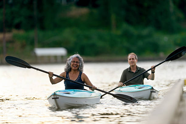 istock Cute elderly diverse couple kayaking together 607499426