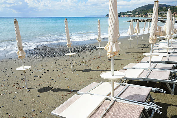 istock beach beds and beach umbrellas empty by the sea 607500522