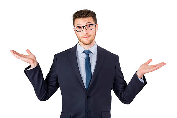 istock Expressive businessman shrugging his shoulders 607501390