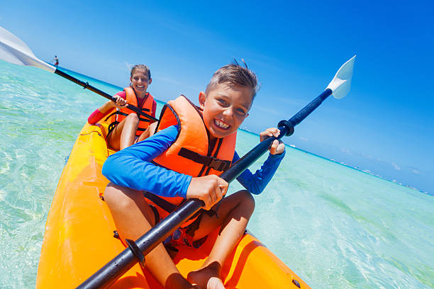 istock Kids paddling in kayak 607501996