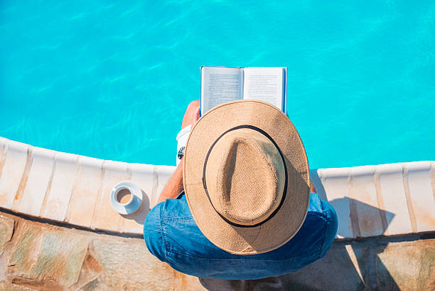istock photo of a man reading a book 607502082