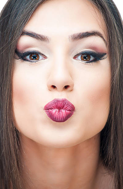 istock Young woman puckering 607502246