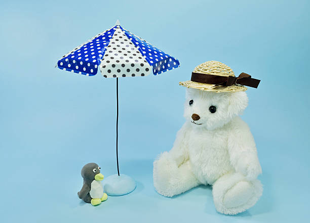 A white bear and a penguin have time at a beach.