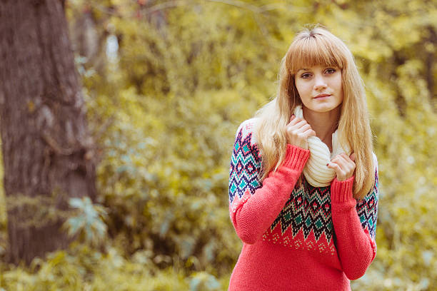 Fall concept - autumn woman in park. Beautiful young modern woman smiling happy and cheerful