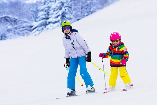 istock Kids siblings skiing in the mountains 607503826