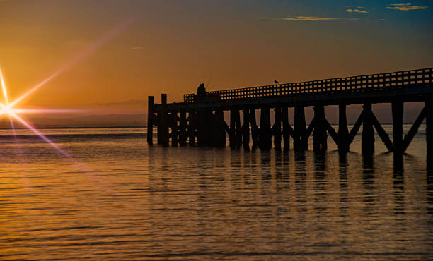 istock Orange sunrise at Cornwallis with flare 607504484