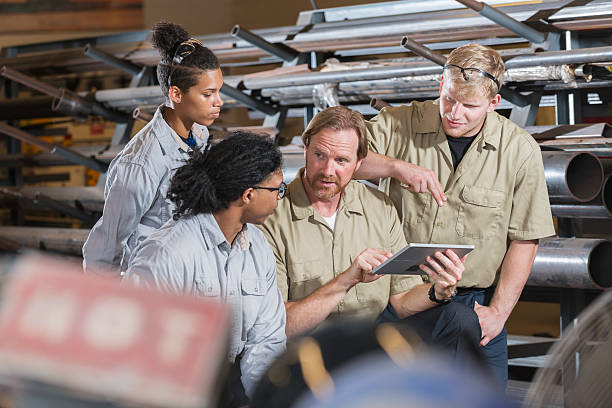 istock Multi-ethnic group of factory workers with supervisor 607504562