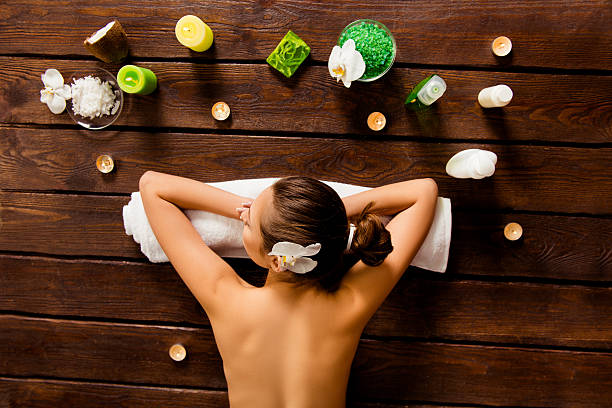 istock pretty woman lying in spa salon and relaxed 607508320