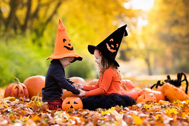 istock Kids playing with pumpkin on Halloween 607508376