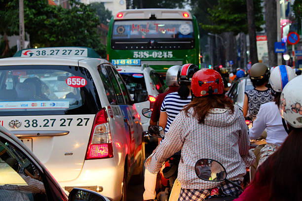 Crowded, chaotic traffic at Ho Chi minh city Ho Chi Minh City, Viet Nam - August 23, 2016: Crowded, chaotic scene of Ho Chi minh city in rush hour, group of traffic vehicle as motorcycle, car stop moving slow, stuck in crowd, overload situation at Vietnam chaotic traffic ho chi minh city vietnam stock pictures, royalty-free photos & images