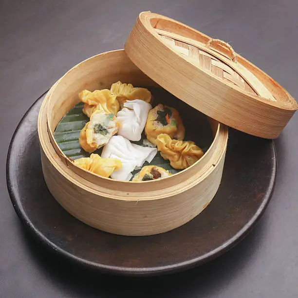 Photo of Dumplings inside of bamboo steamer