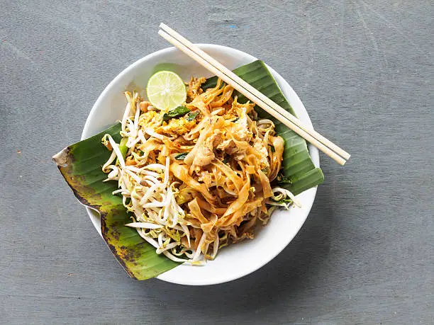 Top view pad thai of thai food noodles style and street food on wooden table