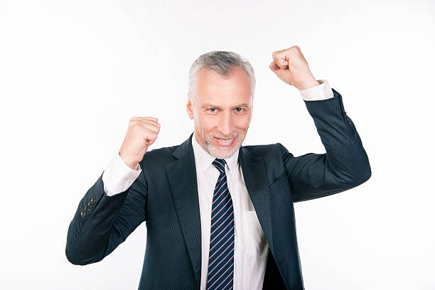 istock old confident businessman celebrating his success 607586128