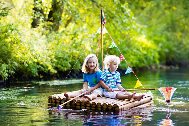 istock Kids on wooden raft 607586874