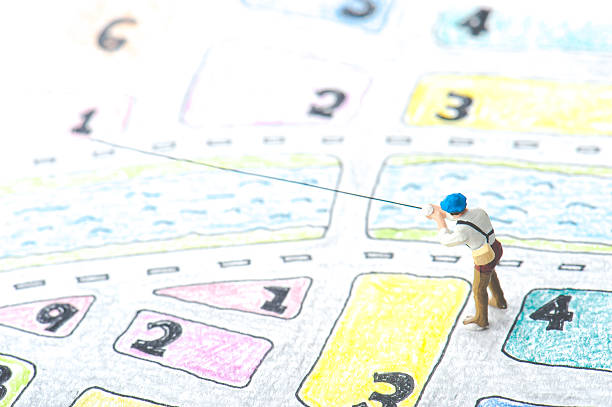 istock Handwritten maps and miniature human 607587744