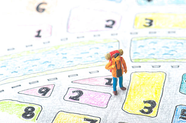 istock Handwritten maps and miniature human 607587756