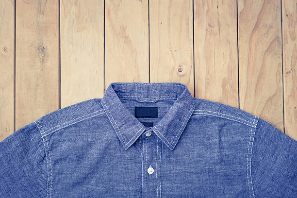 istock Blue jeans on wooden background top view 607588082