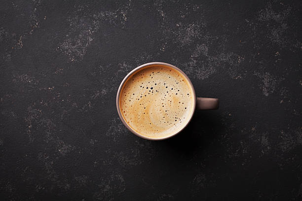 istock Cup of fresh coffee on vintage black table, top view 607589400