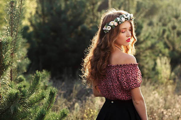 istock Beautiful girl standing in forest half-turned 607590880