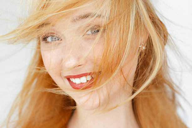 istock Amazedly smiling red-haired girl portrait 607590984