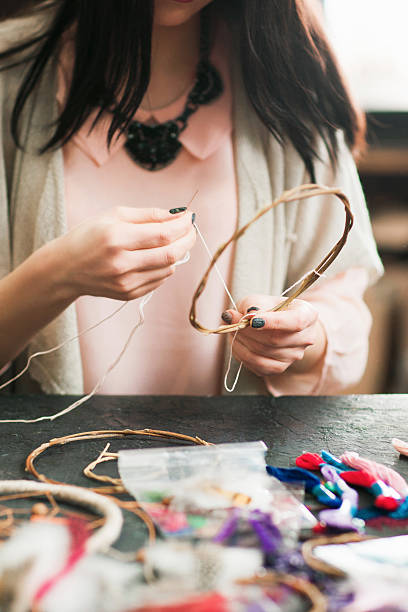 istock Female artisan making dream catcher at art studio 607591134