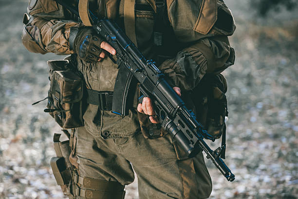 istock soldier in camouflage holding a gun. 607592262