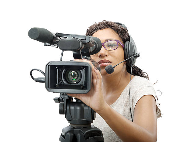 young African American women with professional video camera a young African American women with professional video camera and headphone on white camera operator stock pictures, royalty-free photos & images