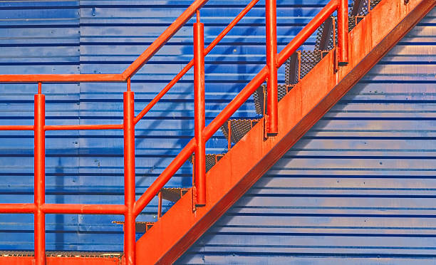 istock part of red fire escape on the blue wall 607594194